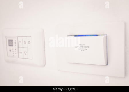 insert keycard sign electronic lock on wall for open switch electronic Stock Photo