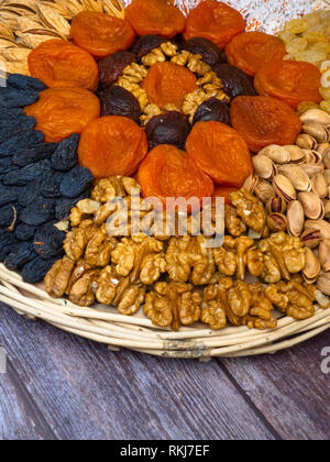Dried fruits an nuts for healthy heart, full of vitamins and potassium, antioxidant. Organic food for everyone's health on wooden surface Stock Photo