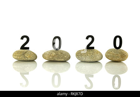 New years resolution 2020 concept, Wooden year number on stones isolated on white background with reflection and copy space Stock Photo