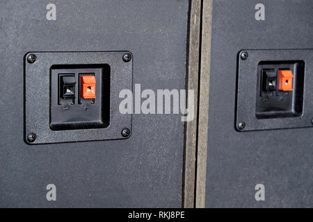 Cable connection sockets on rear side speaker system boxes side view closeup Stock Photo
