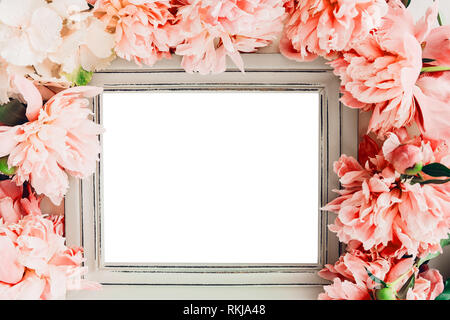 Pastel wooden frame decorated with coral peonies flowers, empty space for text Stock Photo