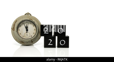 2020 New Years eve celebration. Minutes to midnight on an old watch isolated on white background Stock Photo