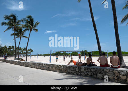 Young people playing beach volleyball in South Beach, Miami Beach, Florida, USA. Friends on summer vacation near the sea in America Stock Photo