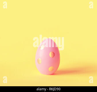 Easter egg on pastel yellow background. Happy Easter concept. Minimal concept Stock Photo