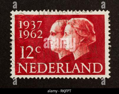 HOLLAND - CIRCA 1960: Stamp printed in the Netherlands shows the king and queen (Juliana), circa 1960.