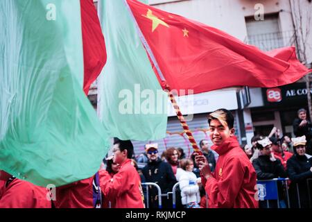 A Man With Coloured Hair Parades Through The Streets Holding A Flag Of The People S Republic Of China During The Celebrations Madrid Celebrates The Chinese New Year With A Great Parade Full