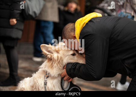 London, UK, 10 February, 2019. A Chinese man with his dog during Chinese New year celebration at China Town, SOHO, London, UK. Credit: Harishkumar Shah/Alamy Live News Stock Photo