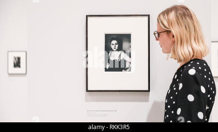 Hayward Gallery, London, UK , 12th Feb 2019.  An assistant looks at 'Woman with a crescent rhinestone brooch', 1957. 'diane arbus: in the beginning' includes nearly 100 photographs that redefine the achievement of one of the most prominent and influential artists of the 20th century. Credit: Imageplotter News and Sports/Alamy Live News Stock Photo