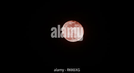 Detailed photo through telescope of waning gibbous moon phase red moon sci-fi Stock Photo