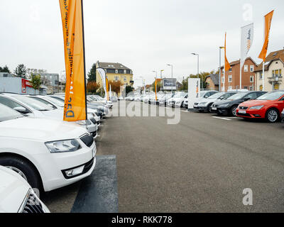 Strasbourg, France - Nov 7 2017: Perspective view - rows of new cars for sale large stock in wide parking lot - Czech Skoda car dealer inventory Stock Photo