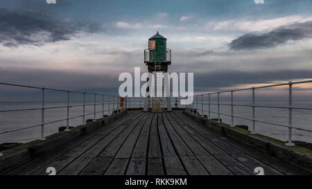 Whitby Abbey pier with lighthouse in the end. Seaside with beautiful sky on the background. Stock Photo