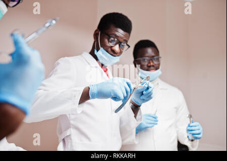 Close uo of three african american male doctors colleagues with tools ...