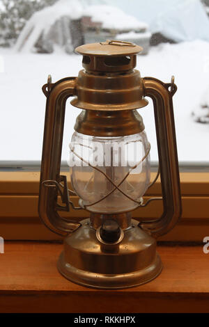 An old lamp standing on a windowsill Stock Photo