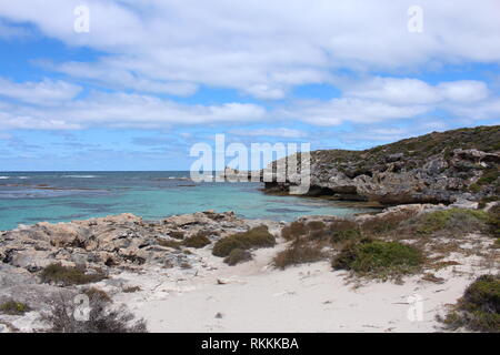 Beautiful rocky cliffs by clear turquoise sea on the coast of Rottnest Island, Western Australia Stock Photo