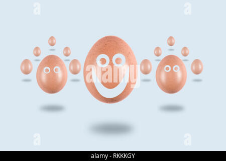 Levitating eggs  with funny painted faces on a light background, conceptual Easter postcard Stock Photo