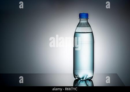 Plastic bottle with water. Gradient background. Mirror reflection Stock  Photo - Alamy