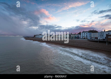 Pink clouds and the view from Deal Pier looking across towards Dover during a February afternoon just before sunset. Stock Photo