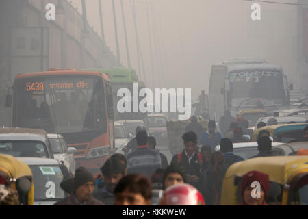 Pedestrians and traffic in hazardous levels of air pollution at Delhi Aero City, New Delhi, India