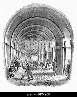 The Thames Tunnel is an underwater tunnel, built beneath the River Thames in London, connecting Rotherhithe and Wapping. It measures 1,300 feet long, running at a depth of 75 feet below the river surface measured at high tide. It was the first tunnel known to have been constructed successfully underneath a navigable river and was built between 1825 and 1843 using Marc Isambard Brunel's and Thomas Cochrane's newly invented tunnelling shield technology, by Brunel and his son Isambard Kingdom Brunel. It was originally designed for horse-drawn carriages, but was never used for that purpose. Stock Photo