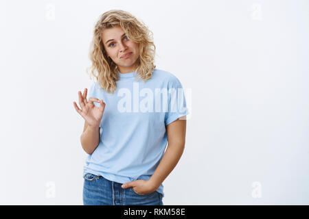 Well, not bad. Portrait of woman reacting to boyfriend efforts being impressed showing okay gesture as giving positive feedback about cool trick of Stock Photo