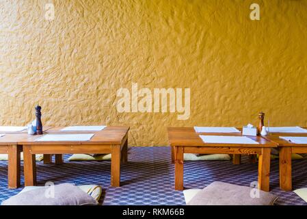 Sit On Floor Low Dinning Table At Restaurant With Yellow Wall In