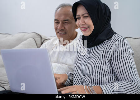senior asian muslim couple using laptop Stock Photo