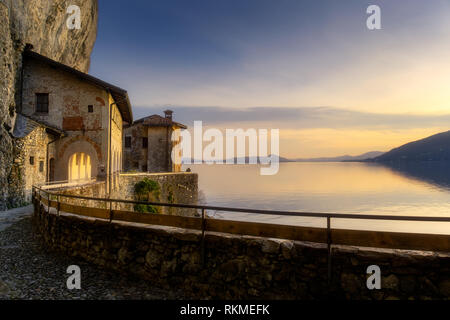 Hermitage of Santa Caterina del Sasso (XIII Century) at sunset, Lake Maggiore, Lombardy, Italy Stock Photo