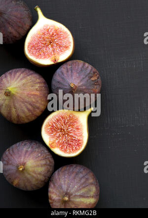 Fresh figs on black surface, top view. From above, overhead. Stock Photo