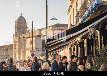 Lisbon, Portugal - 12/28/18: Custard pastries, Pasteis de belem. Long queue filled with tourists for the hundreds of spots in the famous belem shop Stock Photo