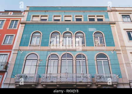 Lisbon, Portugal - 01/03/19: Gorgeous beautiful marine blue and white traditional tiled building with protruding wrought iron balconies and arched win Stock Photo