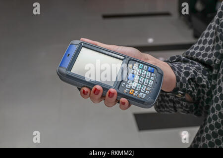 Woman Using Portable Barcode Scanner and Rfid Reader Device Stock Photo