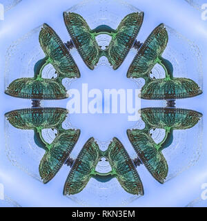 Abstract fountain shapes made from a water fountain. Geometric kaleidoscope pattern on mirrored axis of symmetry reflection. Colorful shapes as a wall Stock Photo
