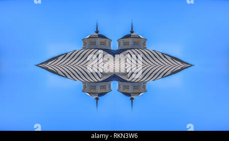 Abstract roof of hut shaped building reflection. Geometric kaleidoscope pattern on mirrored axis of symmetry reflection. Colorful shapes as a wallpape Stock Photo