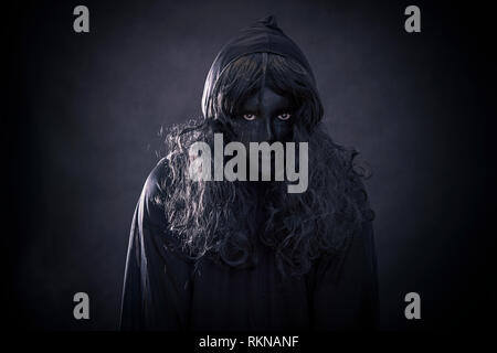 The witch in hooded cloak Stock Photo - Alamy