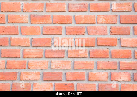 Orange brick wall texture background. Brickwork or stonework flooring interior rock old pattern clean concrete grid uneven bricks design stack. Stock Photo