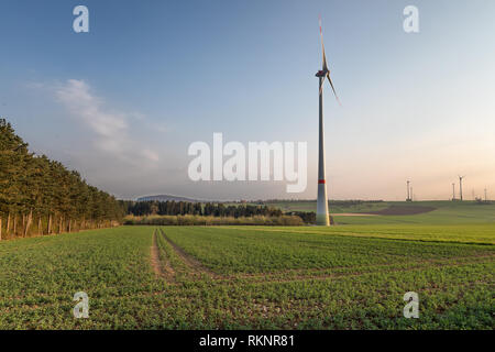 Wind Turbine on the edge of the woods Stock Photo