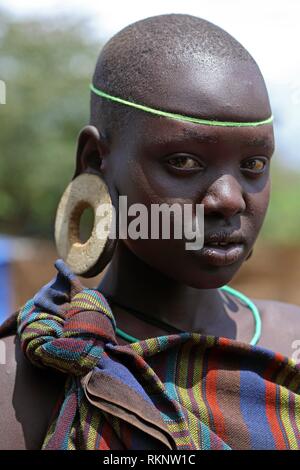 A Traditional Young Mursi Tribe Woman Head Shot with Wooden Plates in ...