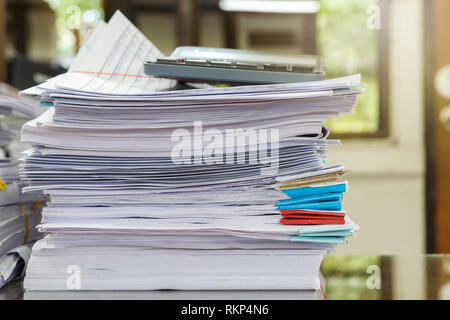 Close up of business papers stack on desk. Pile of unfinished documents on office desk Stock Photo