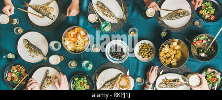 Friends eating fish and chips and drinking beer, wide composition Stock Photo