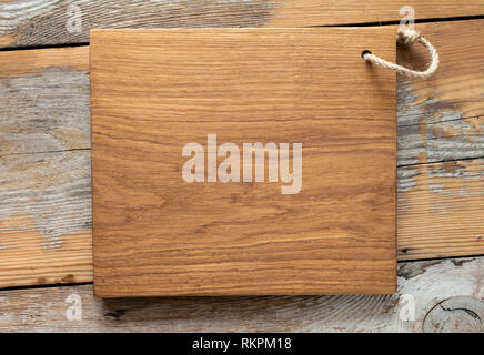 Oak cutting board handmade on wooden kitchen table top view Stock Photo