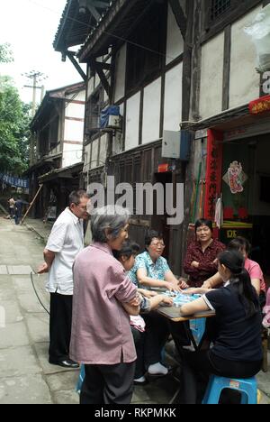 Playing majong in a back street of Ciqikou, a heritage town built during the Ming and Qing Dynasties, an hour's drive outside of Chingqing. Meaning 'P Stock Photo