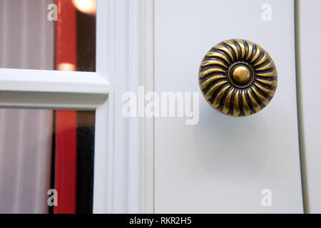 The door knob is made of copper. It is both sturdy and durable, but it looks very old. Stock Photo