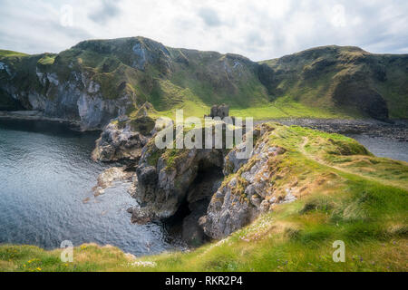 Kinbane Castle is spectacularly situated on the Antrim coast in Northern Ireland, on a long narrow limestone headland projecting into the sea. Stock Photo