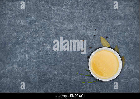 Creative layout made of broth, green onion, black  pepper on light grey background.Food concept.Image with copy space. Stock Photo