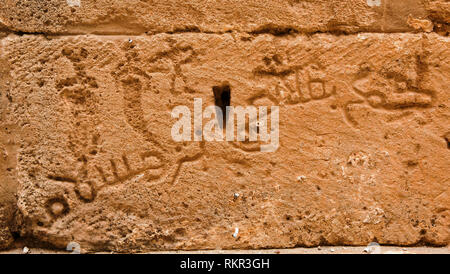 An Arabic writing engraved on the wall of El Jem Stock Photo
