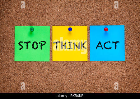 Three sticky notes on cork board with words Stop, Think, Act. Stock Photo