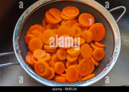 Carrots cut in a colander Stock Photo