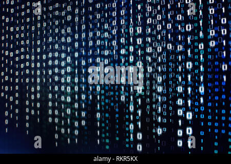 computer data matrix. vertical digital binary code moving motion downward. light up blue one and zero text flowing down. black background space with m Stock Photo