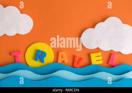 Summer vacation minimal creative concept made of colorful travel letters text and paper sea, sun and clouds on orange sky background. Stock Photo