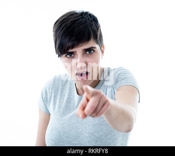 Close up portrait of scared and shocked young woman pointing at something surprising and scary. Looking with fear in her eyes. People and Human expres Stock Photo